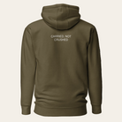 Brown hoodie with text 'CARRIED, NOT CRUSHED' on the back against a white background