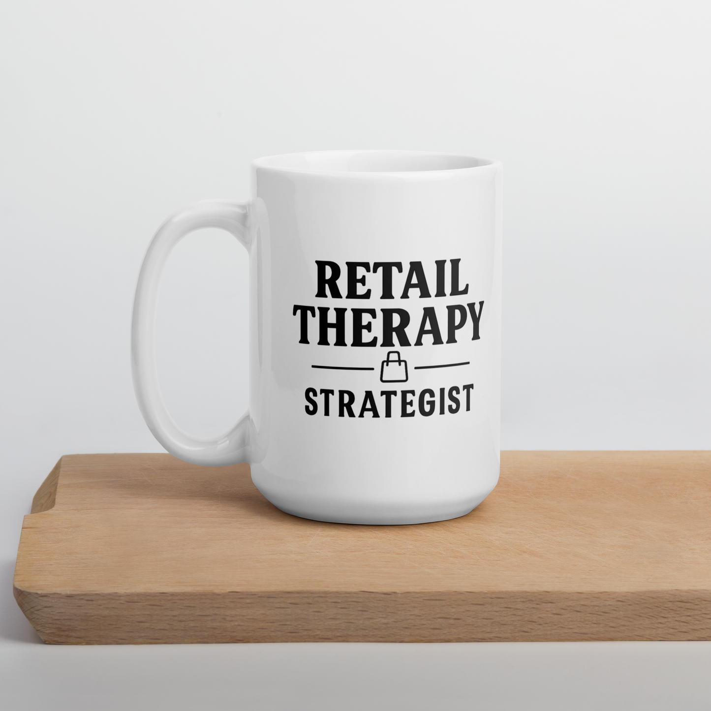 White mug with 'Retail Therapy Strategist' text on a wooden surface