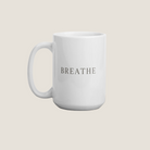 White coffee mug with the word "Breathe"