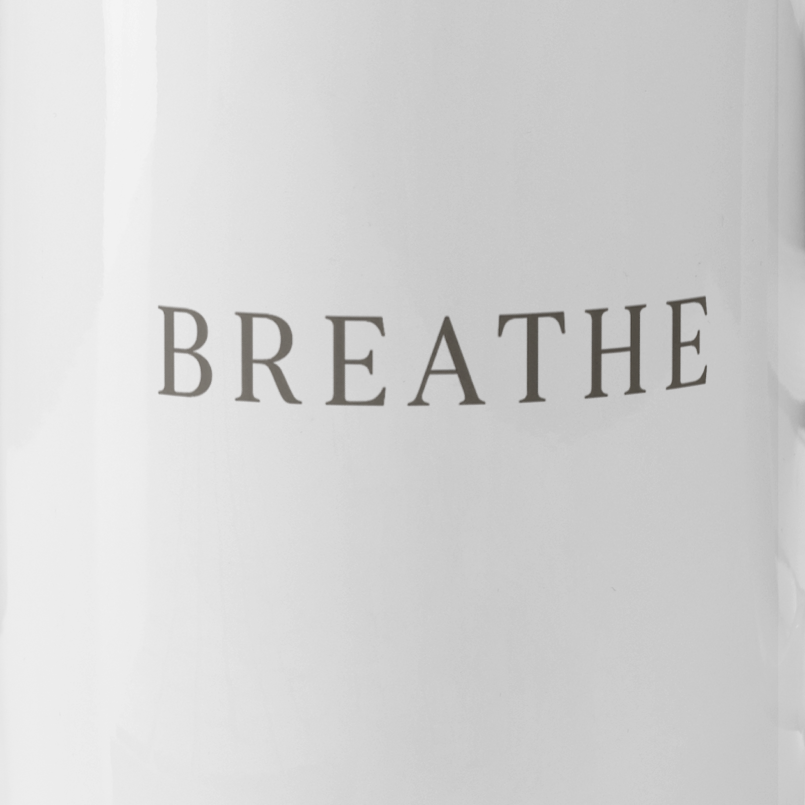 Close up of the word Breathe on a white coffee mug