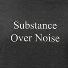 Black t-shirt with white text 'Substance Over Noise .' on a white background