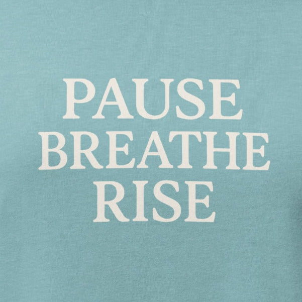 Teal t-shirt with 'PAUSE BREATHE RISE' text on a white background
