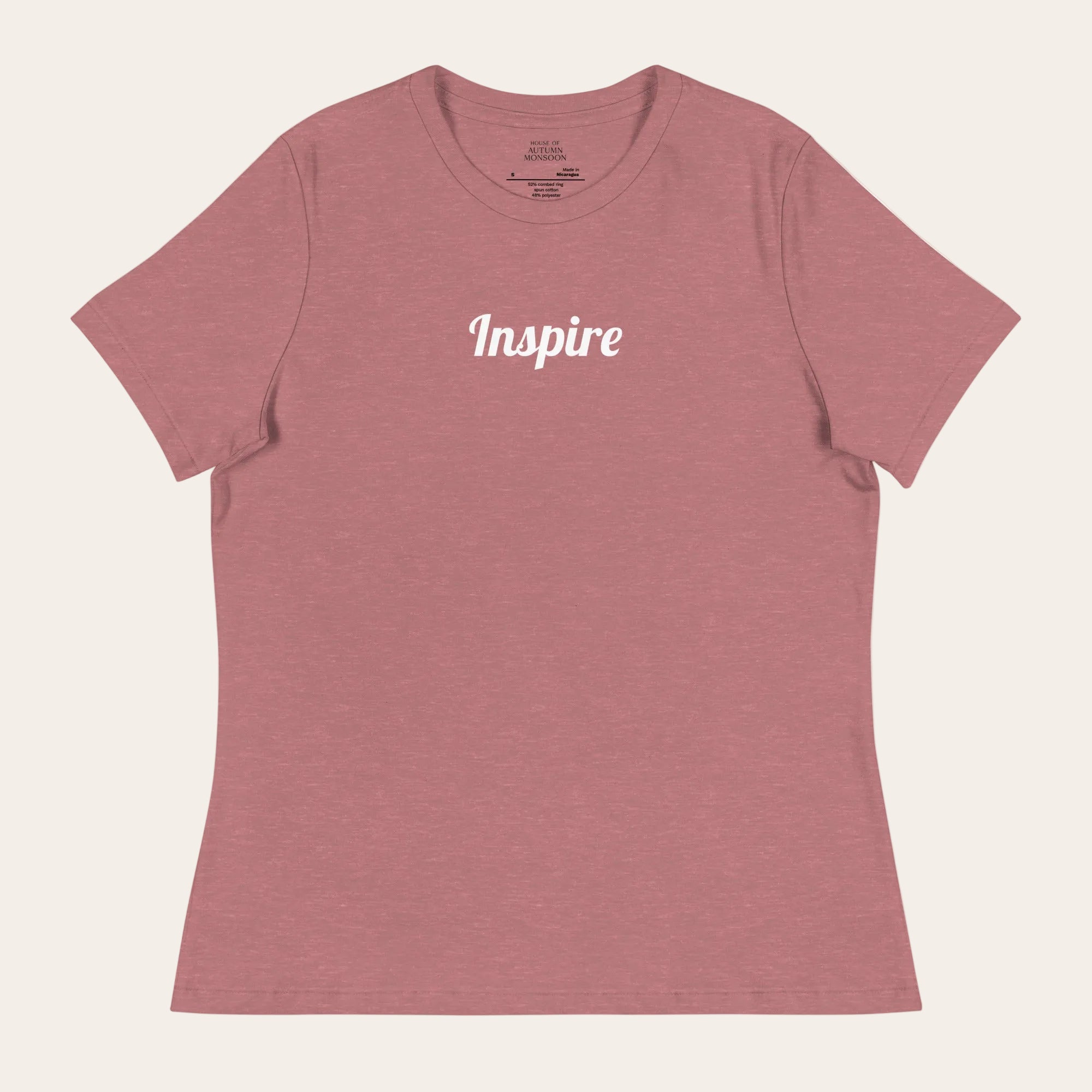 Pink t-shirt with 'Inspire' text on a white background